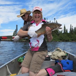 Excited guest about to release a huge brook trout at Igloo Lake Lodge in Labrador