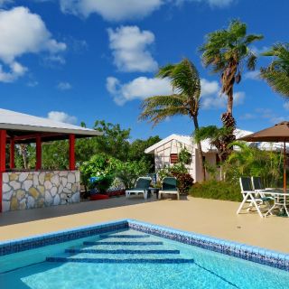 Lounge chairs and gazebo with barbecue for guests to use