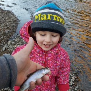 My dauther and her first smallest trout